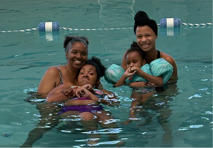 Sherri and Lauren float in a pool with friends